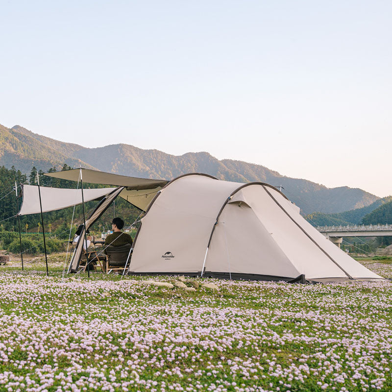 Large Tunnel Tent in use for family camping, set up with vestibule