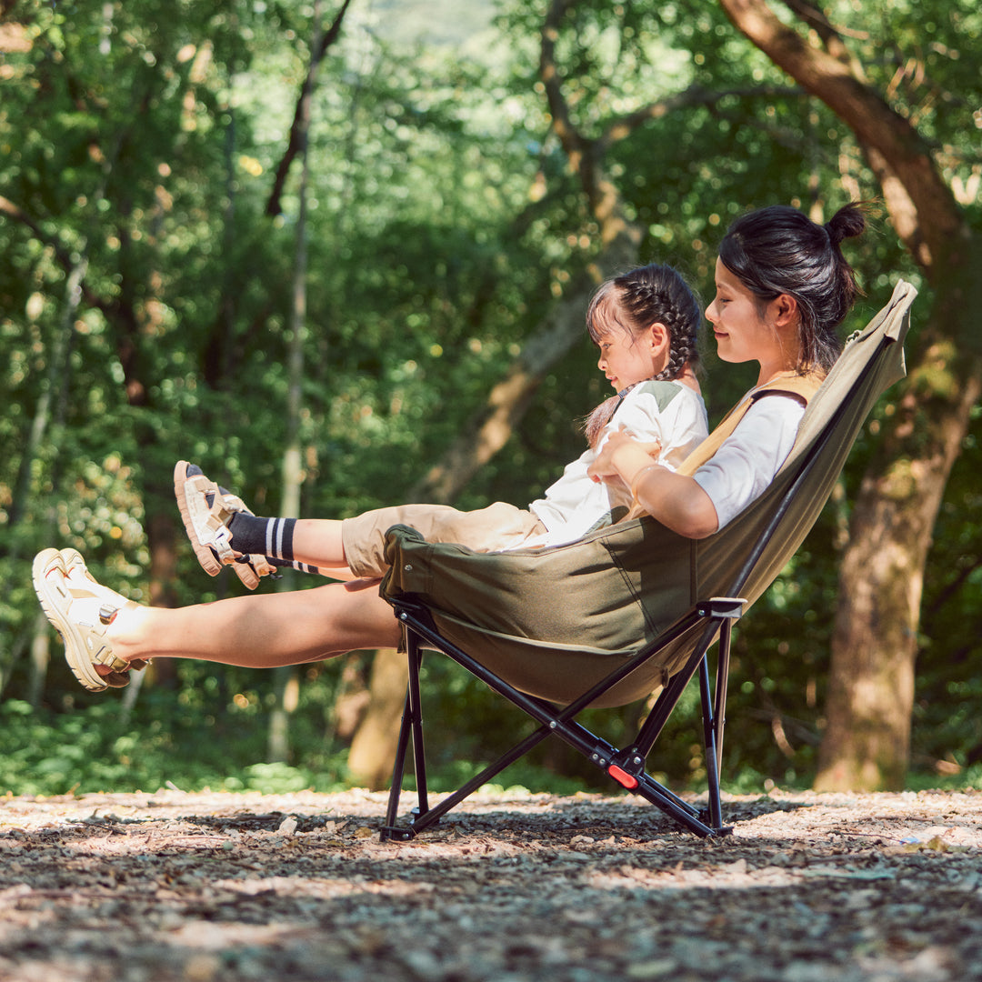 Naturehike Seastar padded camping chair in army green set up at campsite