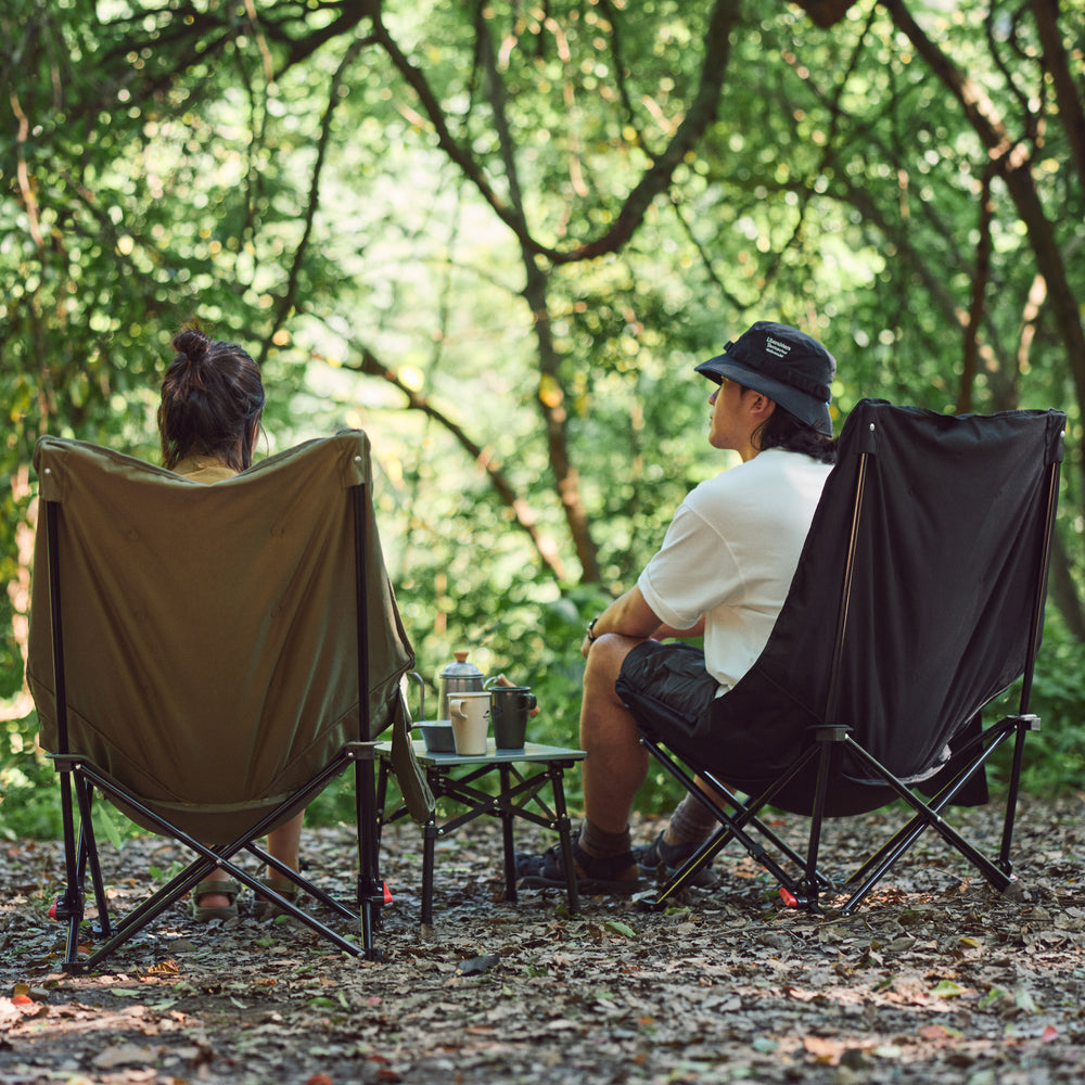 Naturehike Seastar padded camping chair in army green set up at campsite