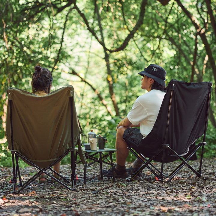 Naturehike Seastar padded camping chair in army green set up at campsite
